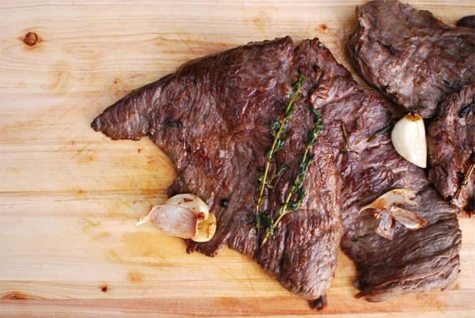 pan seared skirt steak on wood cutting board