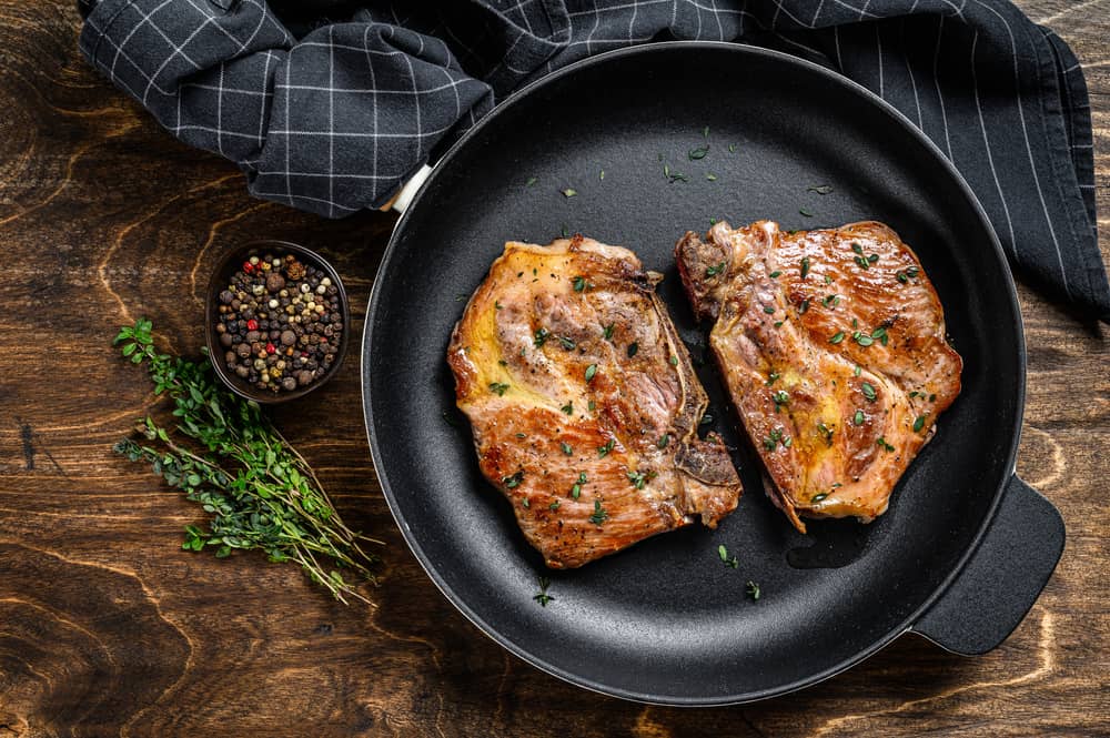 oven cooked pork steaks in frying pan