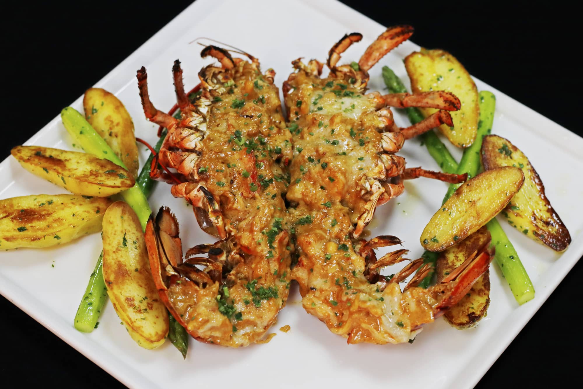lobster thermidor with glazed potato and asparagus