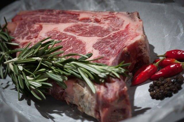 raw steak with seasonings