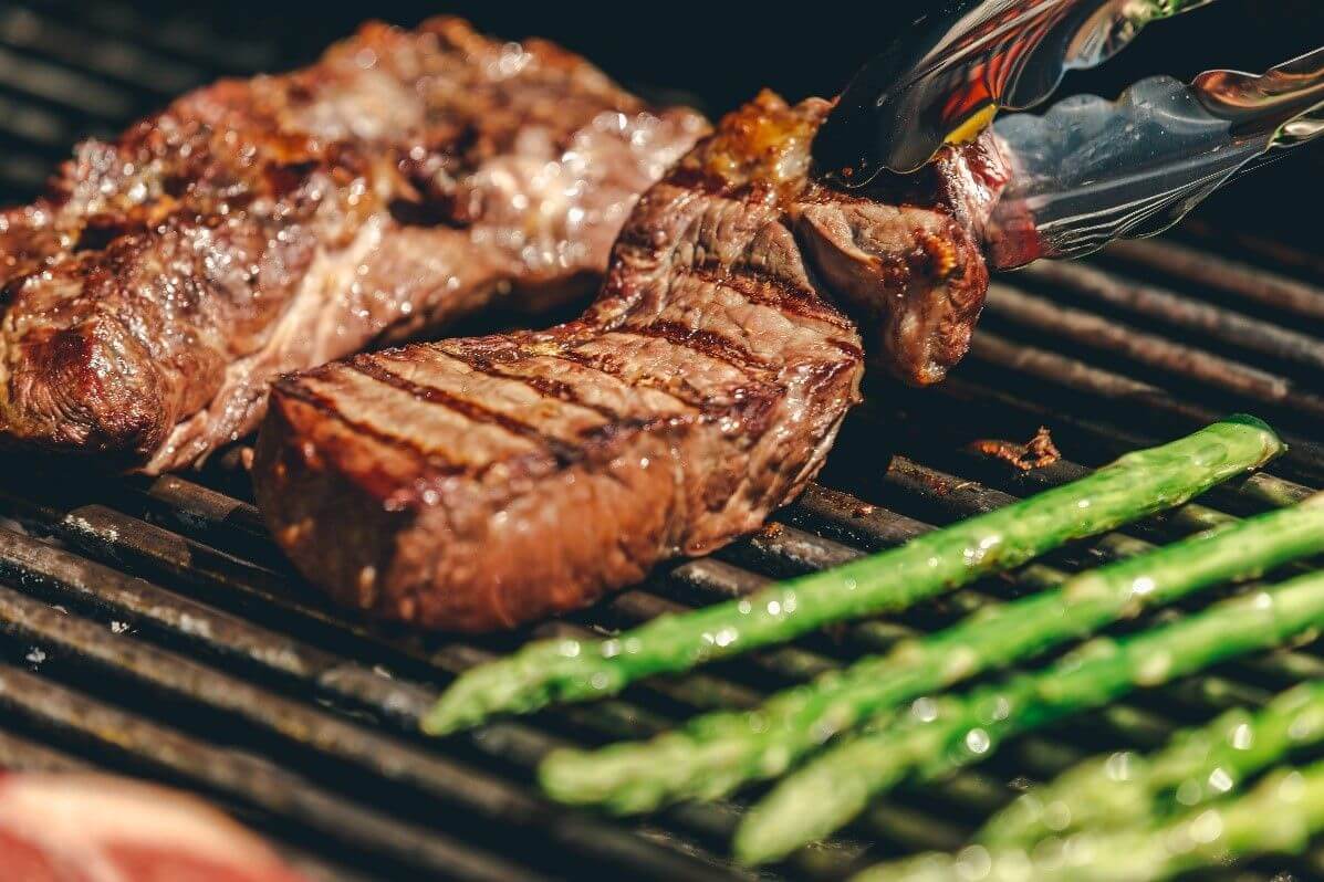 strip steak being grilled