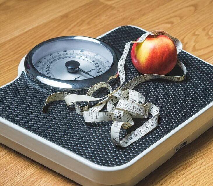 tape measure and fruit on a weight scale