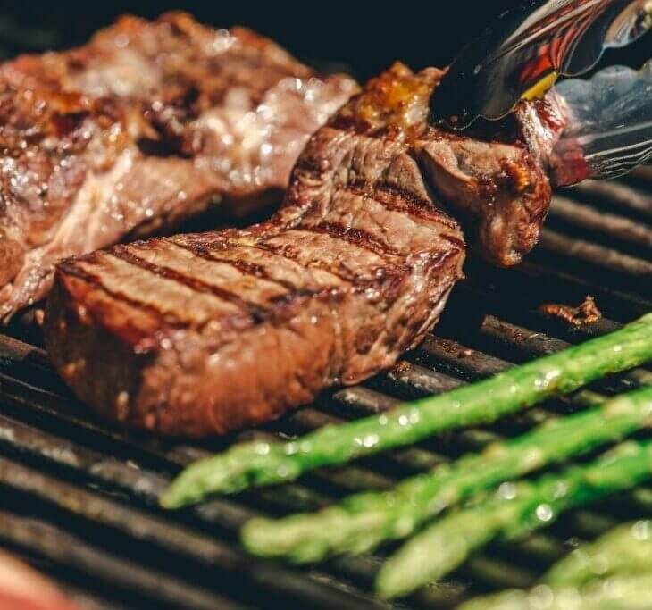 strip steak being grilled