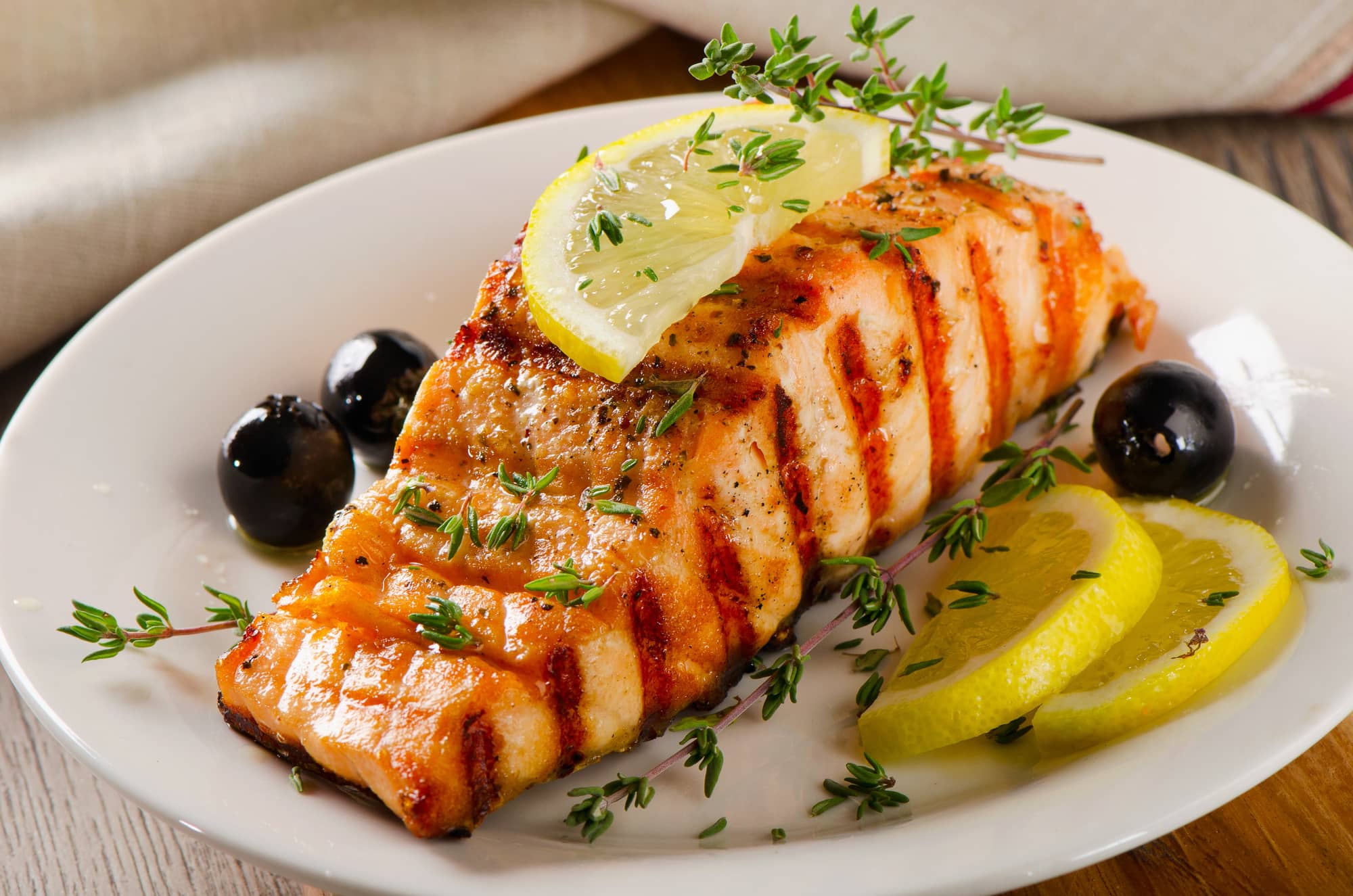 cooked salmon with lemon slices and olives