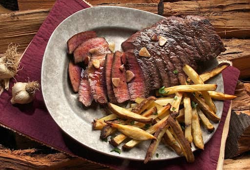 reverse seared flank steak served with french fries