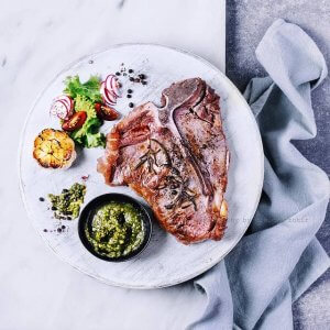 air fryer tbone steak with sides served on platter