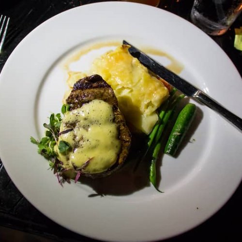 filet mignon with bearnaise sauce served on platter with beans