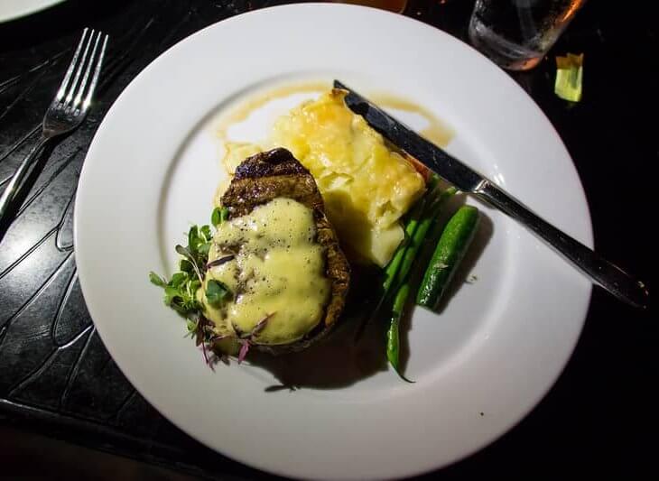 filet mignon with bearnaise sauce served on platter with beans