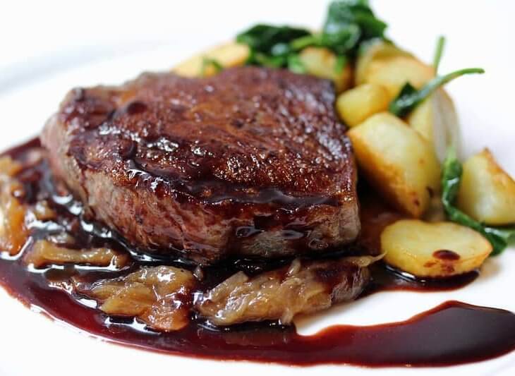 filet mignon in a sauce served on a platter