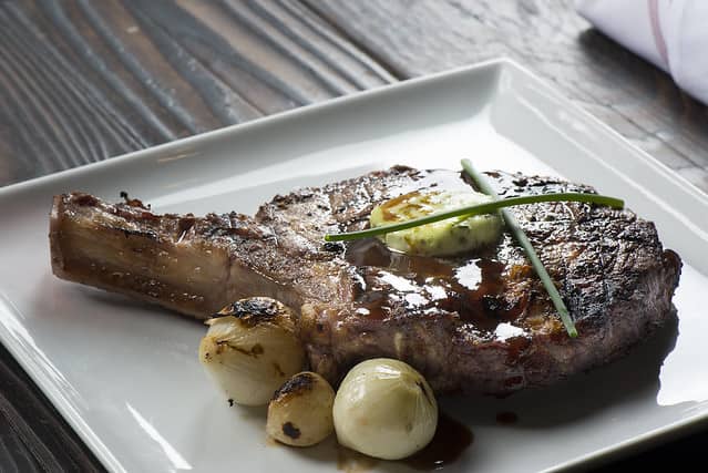 reverse seared cowboy ribeye steak on platter