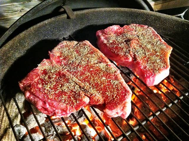 uncooked seasoned tbone steaks ready to grill