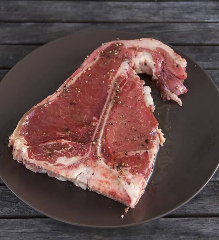 uncooked seasoned t-bone steak ready for slow cooking