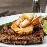 flank steak with shrimp on top in a lime marinade