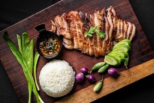 soy marinated flank steak served with rice and vegetables on platter