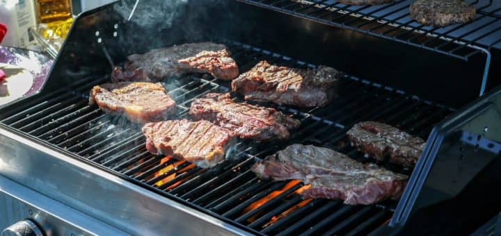 steaks on a gas and charcoal grill