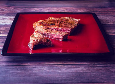 cooked flank steak served on a platter
