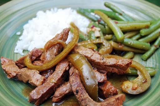 tri tip steak with peppers, green beans, and rice