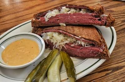 corned beef sandwiches served with pickles and sauce