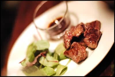 cube steak served with spinach and gravy