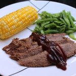 beef brisket served with corn on the cob and green beans