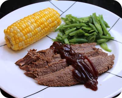 beef brisket served with corn on the cob and green beans