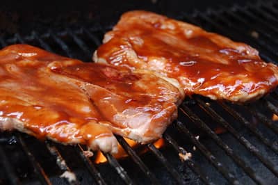marinated pork steaks on the grill