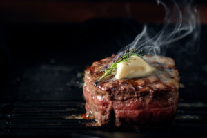 broiled filet mignon with melted compound butter on top