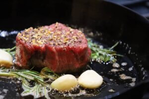 pan seared seasoned filet mignon in cast iron skillet