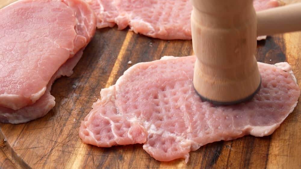 tenderizing pork chops with meat mallet
