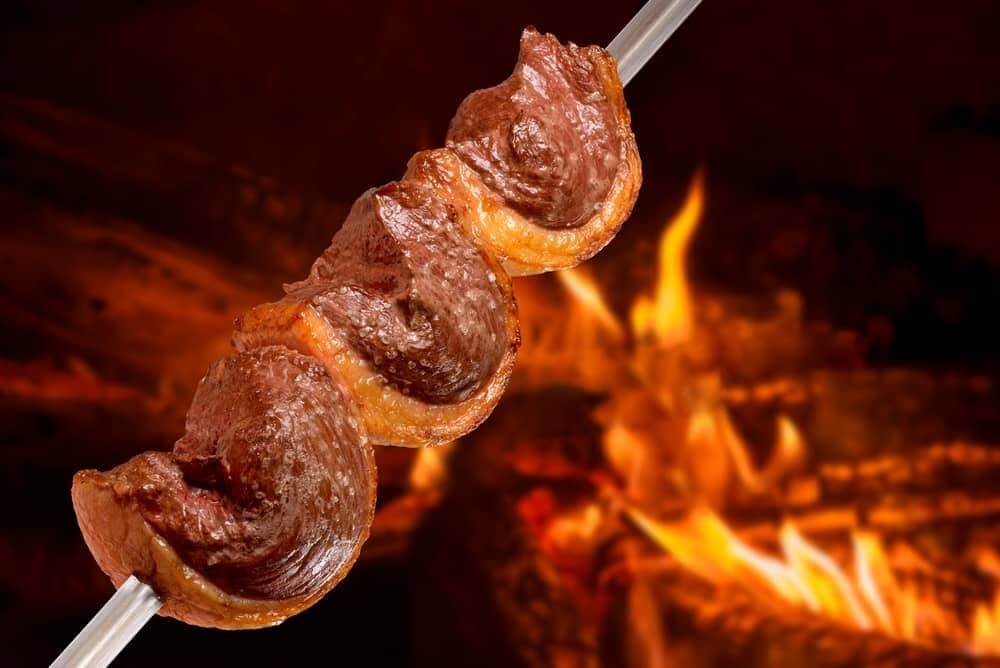 grilling picanha steak on skewers