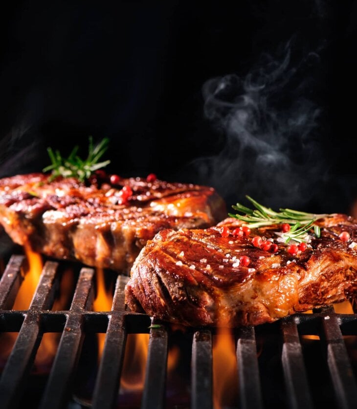 cooking steaks on a grill