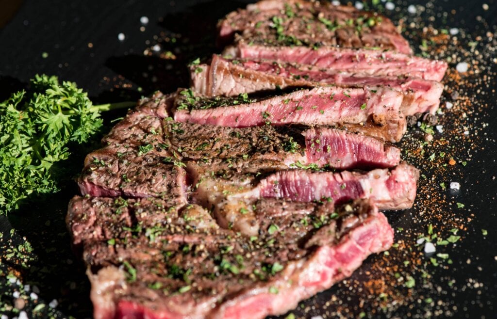 cooked flat iron steak with seasonings